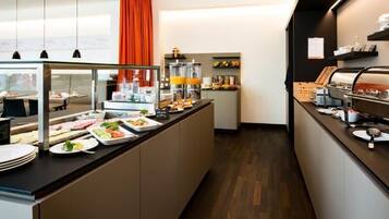 A buffet setup with various food items and a coffee station.