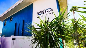 A building with a blue exterior and a sign that reads "Ivory Sands Beach Suites". - Ivory Sands Beach Suites (Clearwater Beach)