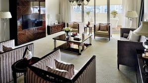 A spacious living room with a flat-screen TV, a coffee table, striped sofas, and a large window with a view. - Marriott Executive Apartments Addis Ababa (Addis Ababa)
