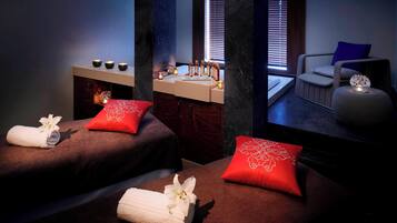 Experience serene relaxation in our tranquil spa area, featuring two massage tables and a soothing ambiance.
