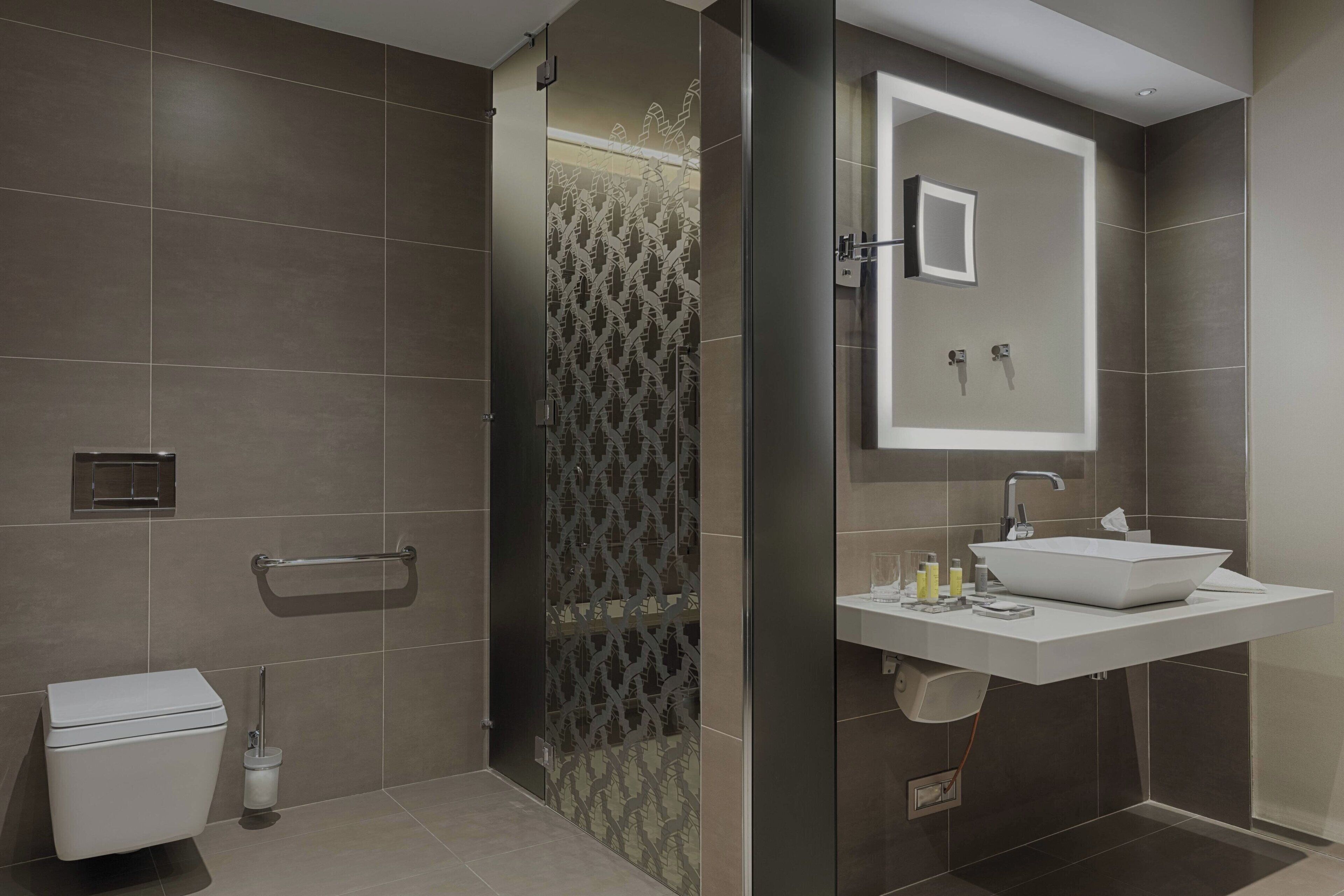 combined shower/bathtub, designer toiletries, hair dryer, bathrobes