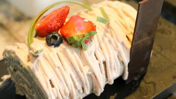 A dessert with strawberries and blueberries on top.