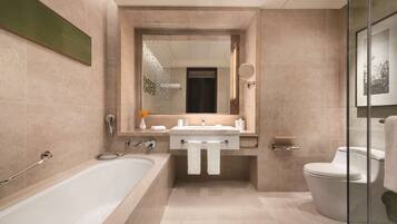 A modern bathroom with a bathtub, sink, and toilet.