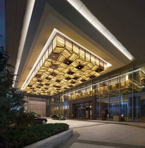 A modern building with a geometric patterned ceiling and large glass windows. - Shangri-La Tangshan (Tangshan)