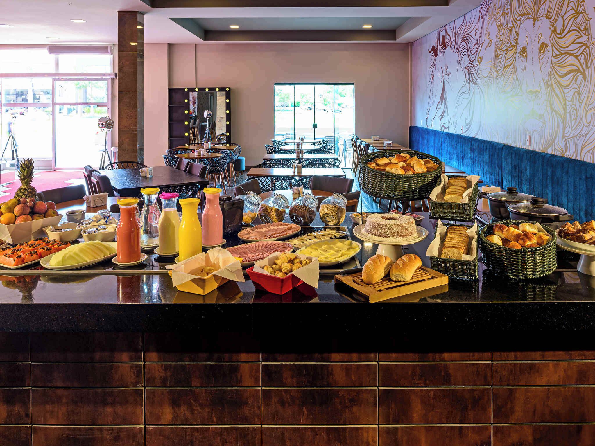 A buffet spread with various food items and beverages.