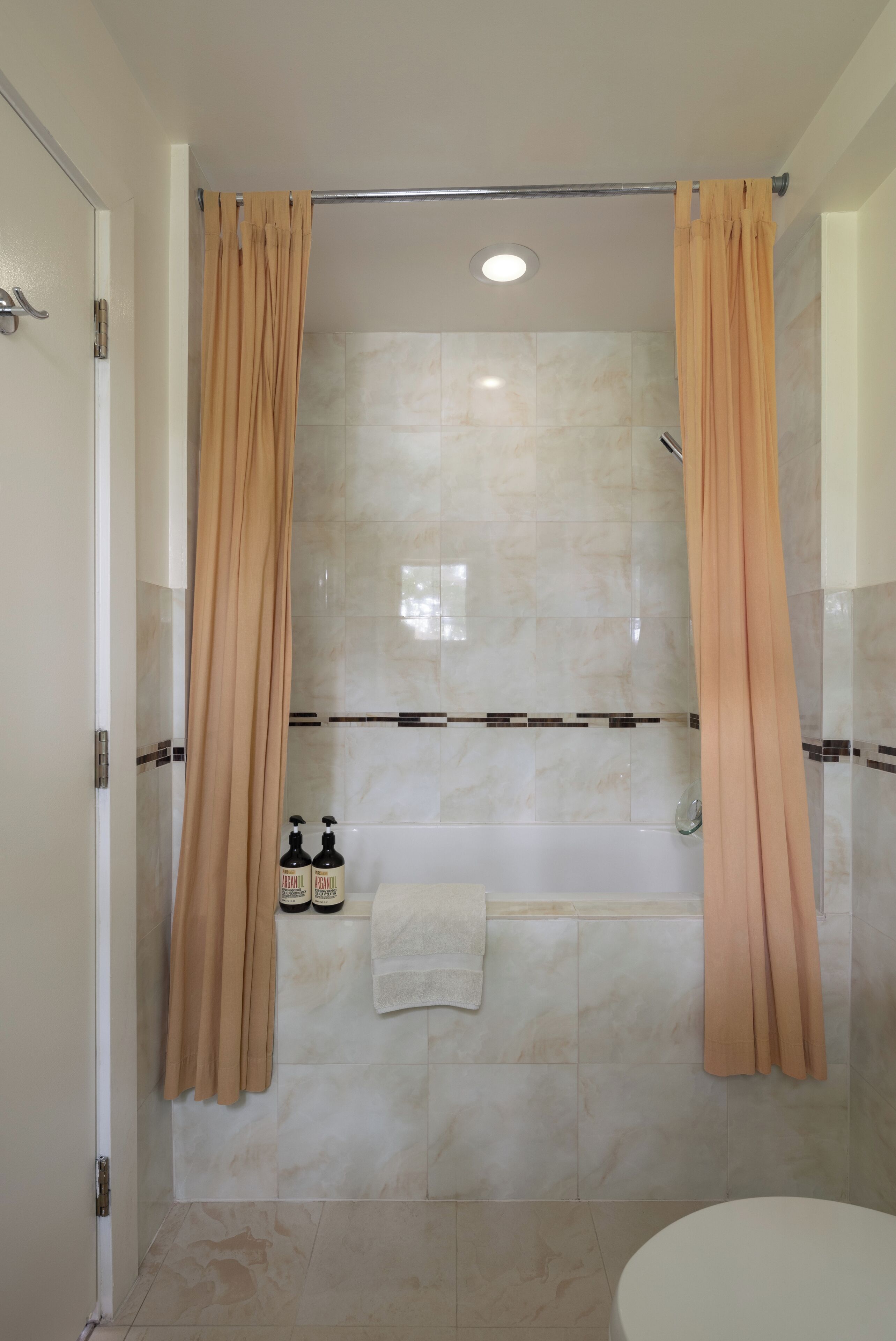 A modern bathroom with a shower, a bathtub, and a toilet.