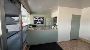 A reception desk with a sign reading 'Welcome to the Budget Inn of Ada.' - Budget Inn By Hotel O Ada OK (Ada)