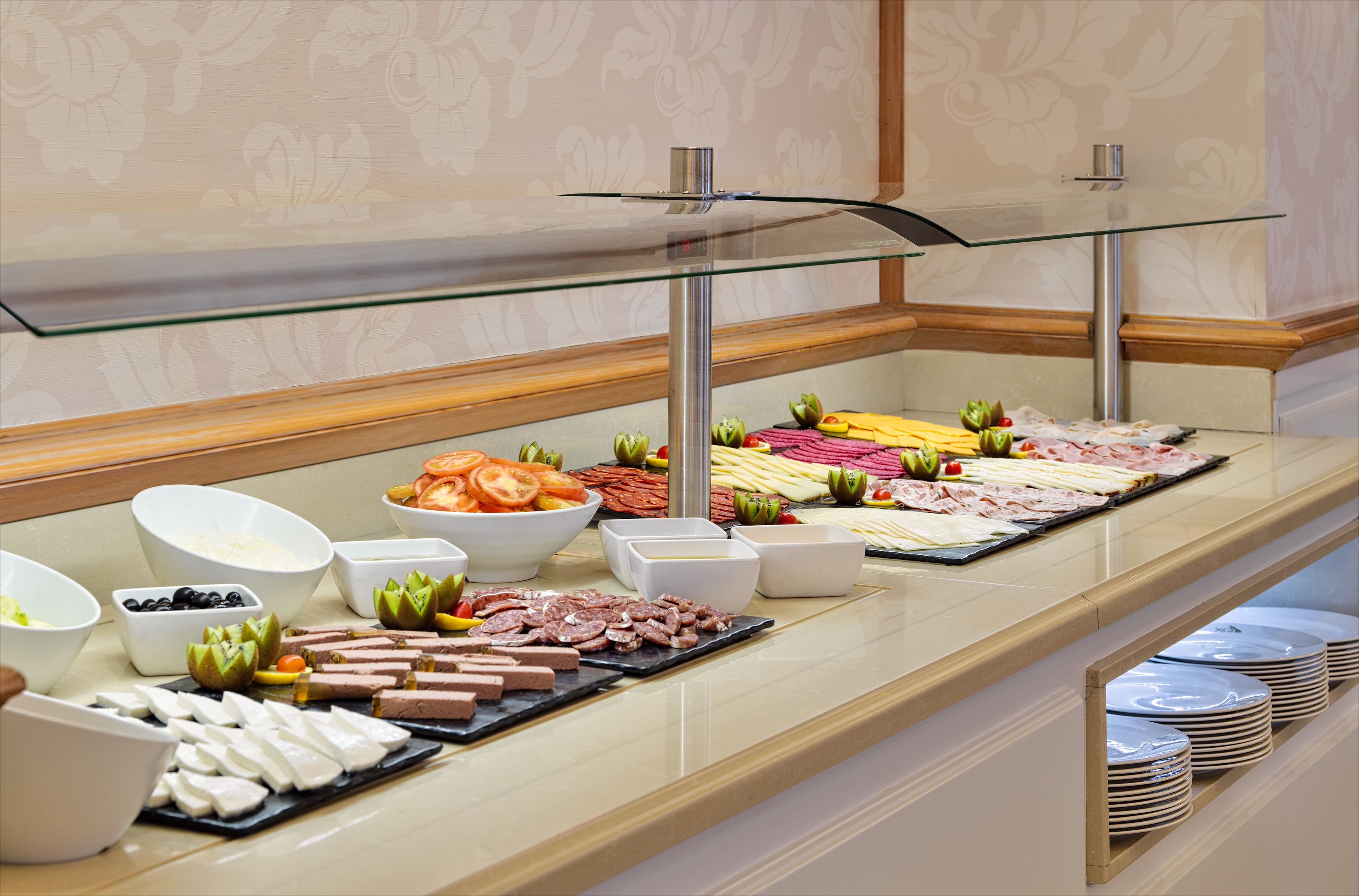 A buffet with various food items and bowls of condiments.