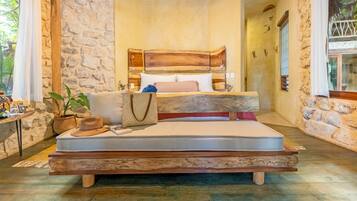 Relax in this rustic-style bedroom with a unique bed and natural stone walls.