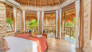 A room with a bed, a hat, and a window. - Alaya Tulum (Tulum)