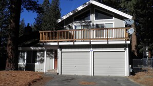 A two-story house with a balcony, two garage doors, and a satellite dish. - 2728 Springwood Dr. (South Lake Tahoe)