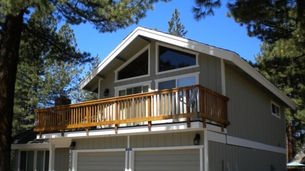A two-story house with a balcony, a garage, and a large window. - 2728 Springwood Dr. (South Lake Tahoe)