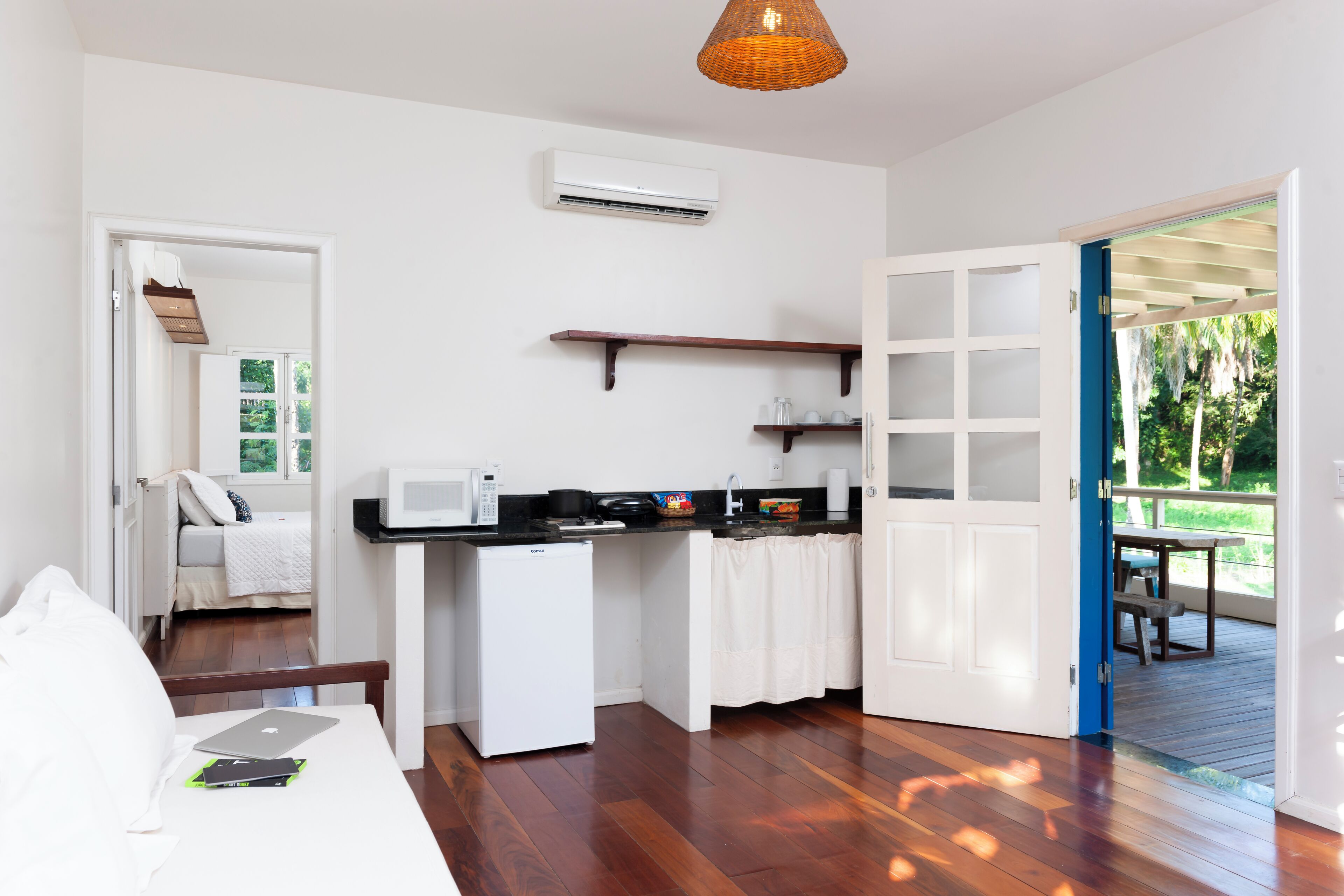 A compact kitchen with a microwave, refrigerator, and a small dining table.