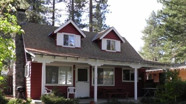 A two-story house with a porch, a small patio, and a wooden deck. - 777 Merced Ave (South Lake Tahoe)