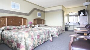 A hotel room with two beds, a desk, a chair, and a bathroom. - Motel Marie-Dan (Sainte-Eulalie)