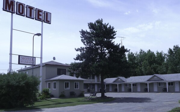 A motel with a sign reading "Motel Marie-Dan" and a large tree in front. - Motel Marie-Dan (Sainte-Eulalie)