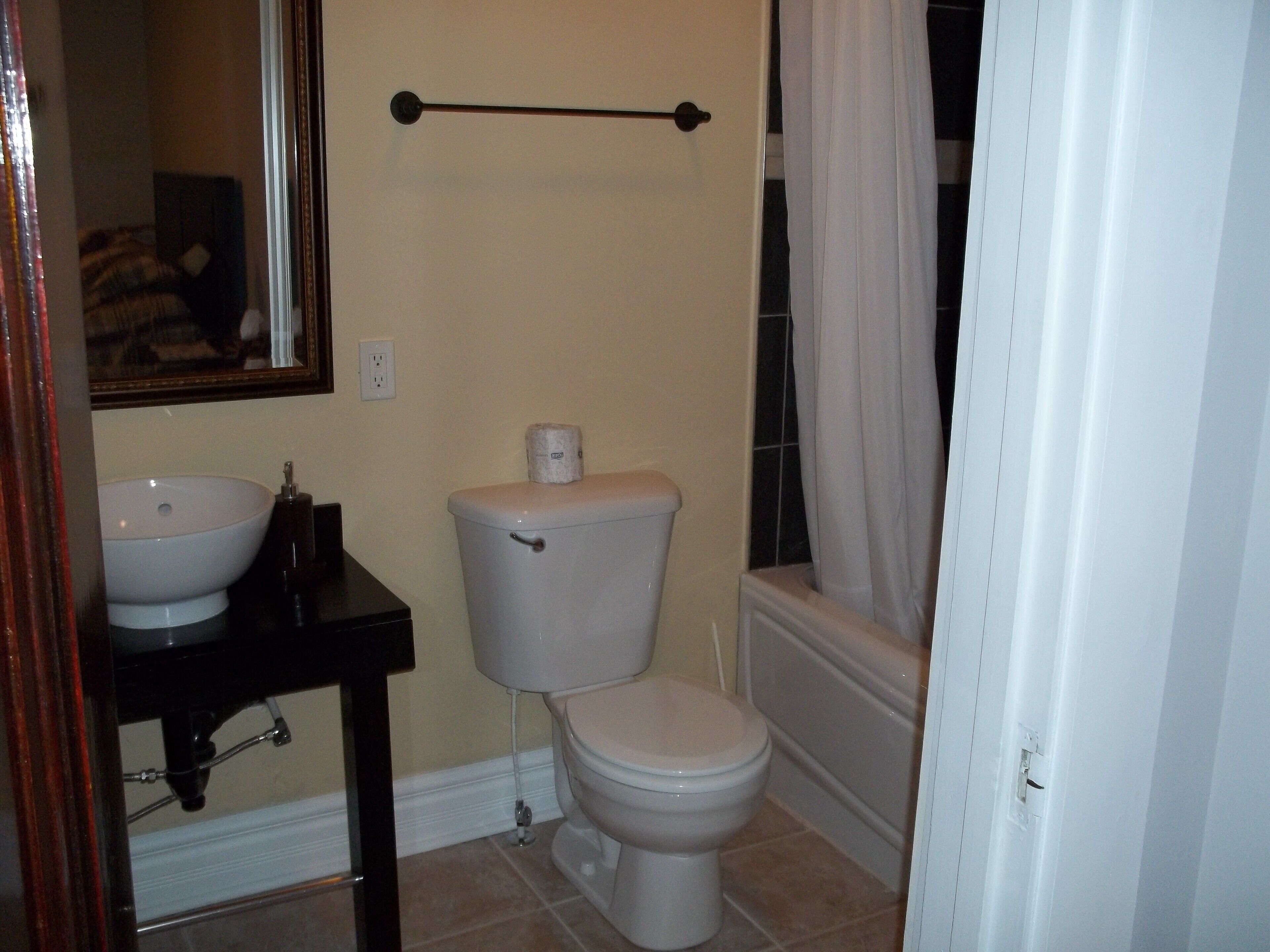 A bathroom with a sink, toilet, and bathtub.