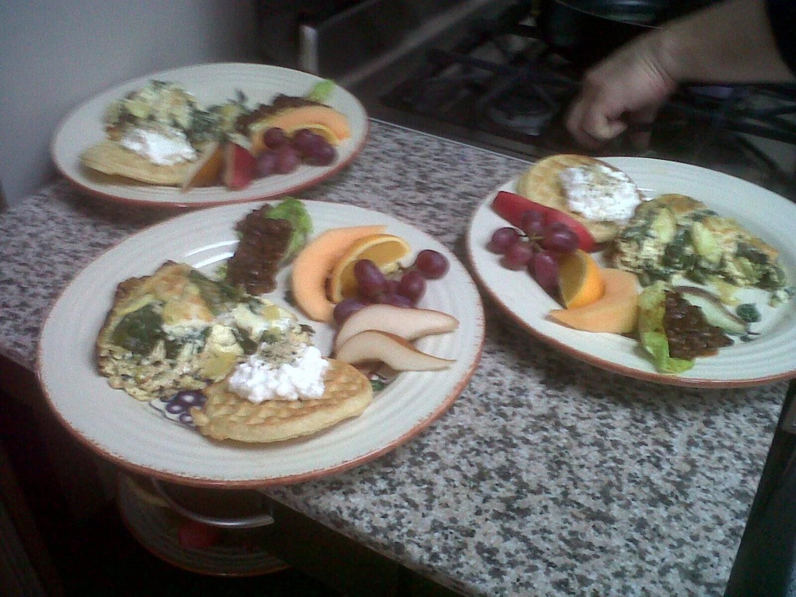 Three plates of food on a granite countertop.