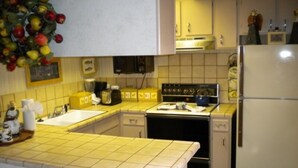 A kitchen with a stove, oven, sink, and cabinets. - 528 Tahoe Keys Blvd (South Lake Tahoe)