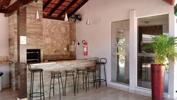 A bar area with a stone wall, a fire extinguisher, and a sign labeled 'Sauna'.