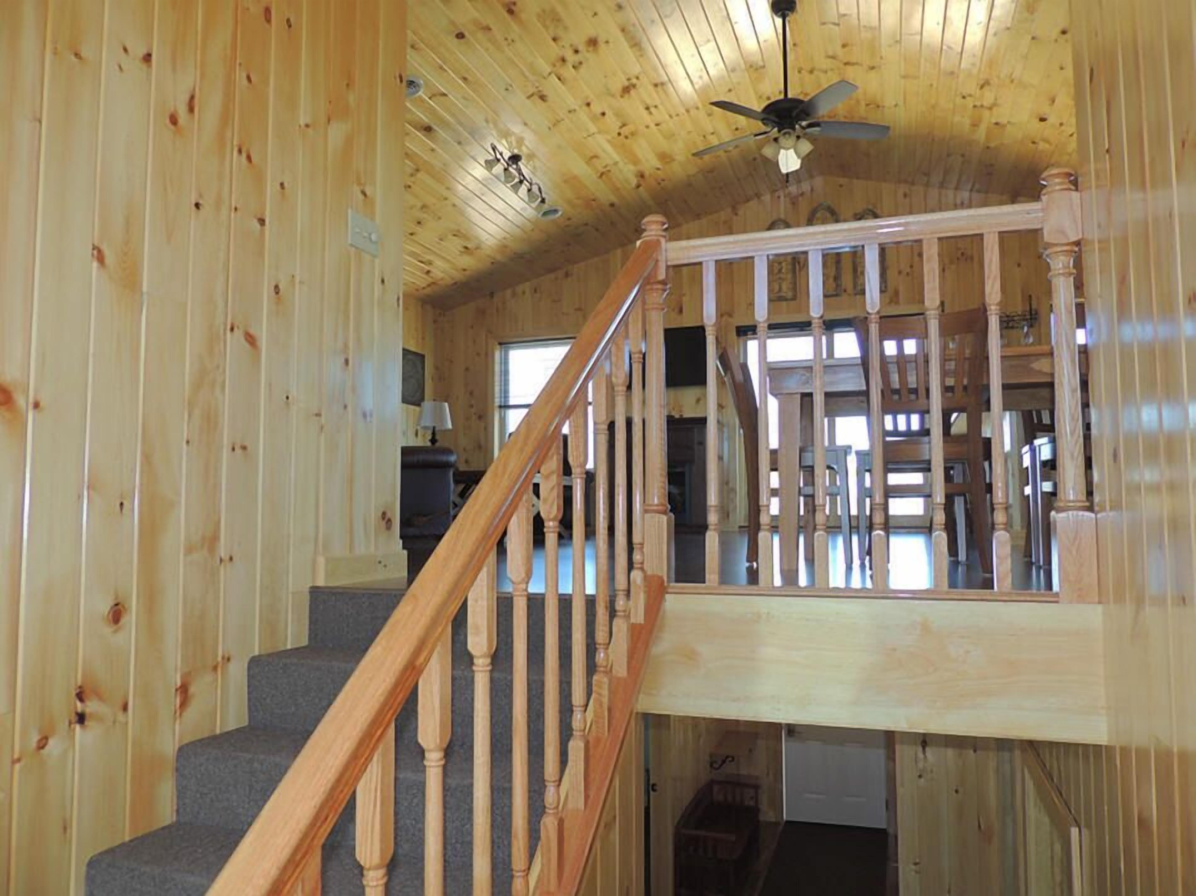 A wooden interior with a staircase leading to an upper level.