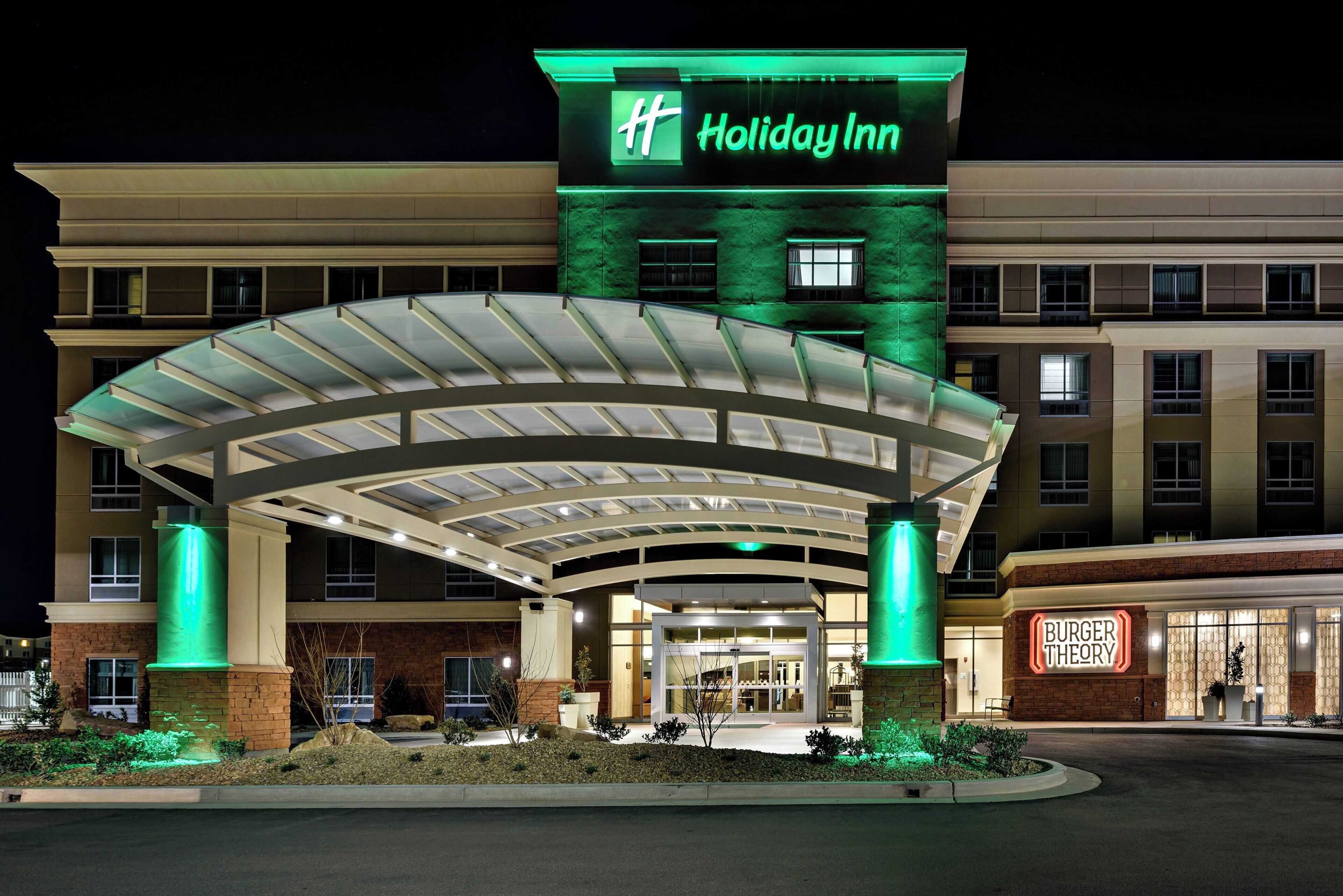 A Holiday Inn hotel with a covered entrance and a Burger Theory restaurant.