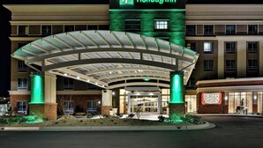 A Holiday Inn hotel with a covered entrance and a Burger Theory restaurant. - Holiday Inn St. George Conv Ctr by IHG (St. George)