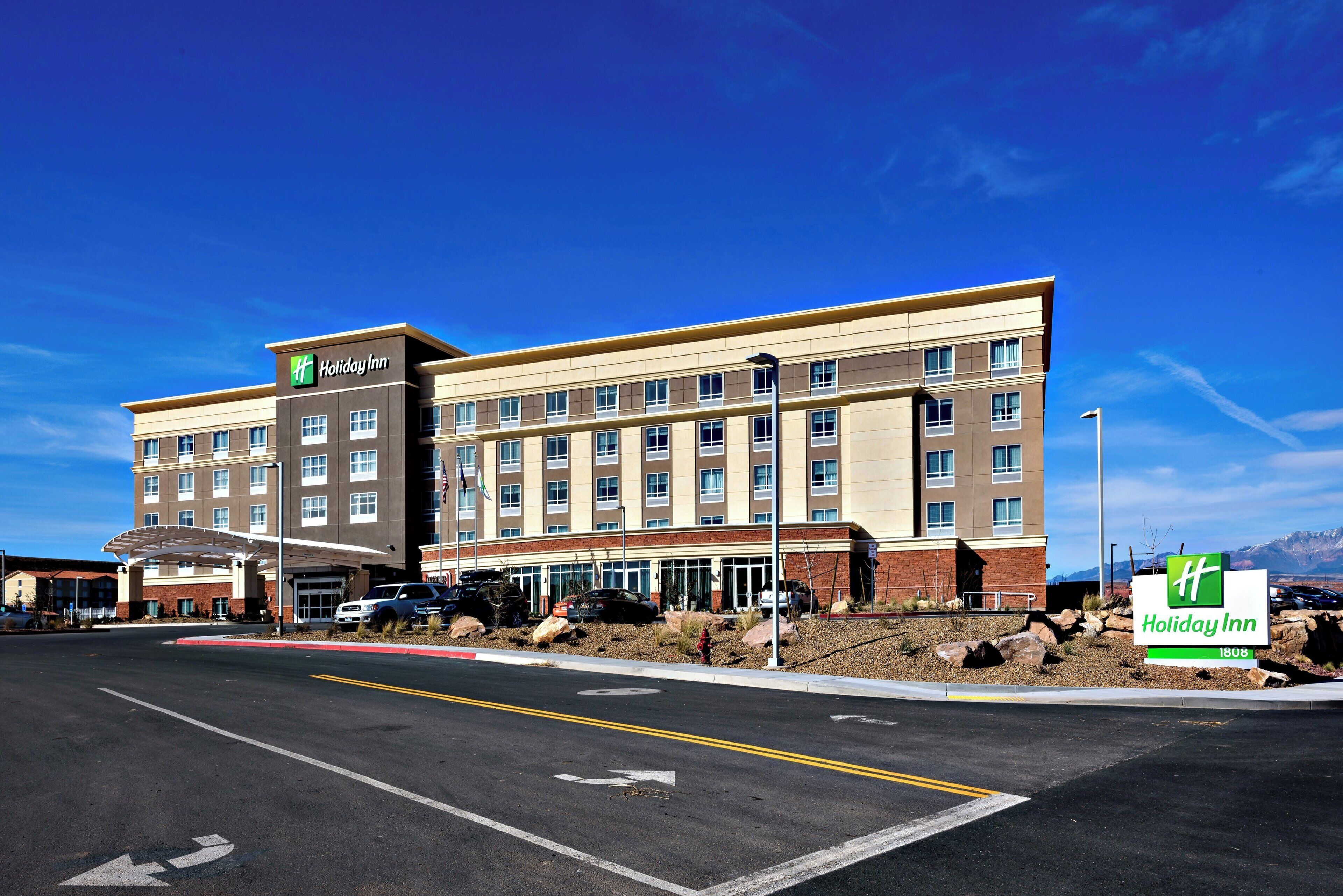 A Holiday Inn hotel with a modern design, featuring a flat roof and a brick facade.