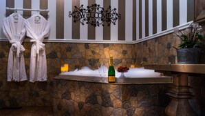 A stone-tiled bar area with a bottle of champagne, glasses, and a welcome sign. - Belle Le Vie (Sassafras)