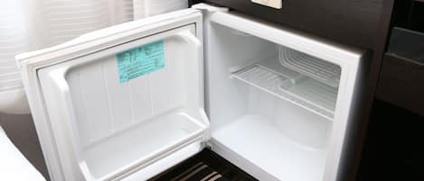 An open refrigerator with a control panel and a note on the door.