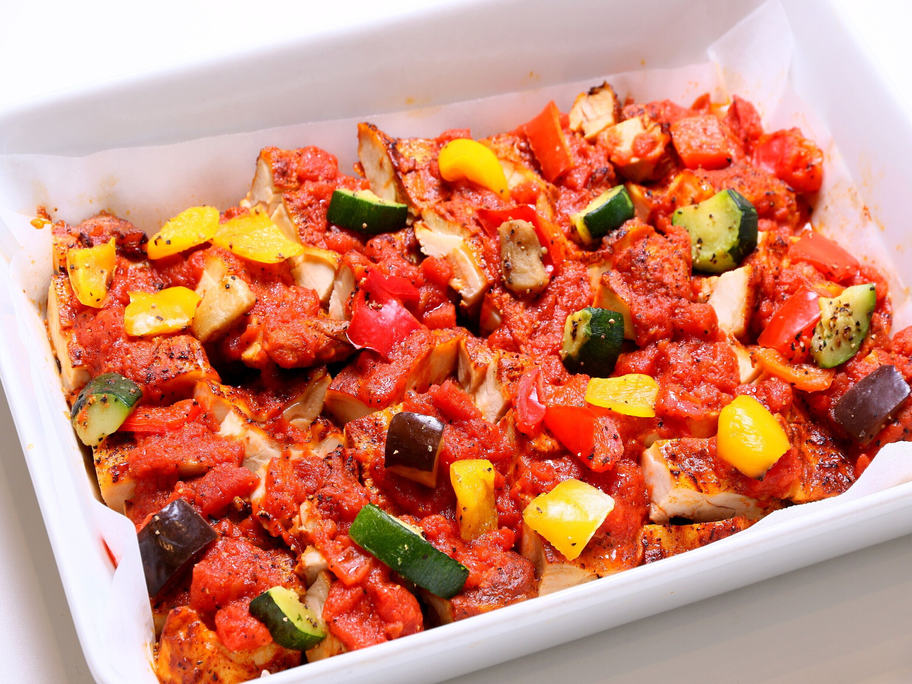 A white rectangular baking dish filled with a colorful vegetable mixture.