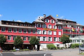 A red building with the sign "HOTEL STERNEN" indicating it is a hotel. - Hotel Sternen (Wildhaus-Alt St. Johann)