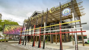 The exterior of the Wiri Handicraft Centre with a modern architectural design, featuring a prominent sign and a colorful mural. - Ajang Hotel (Miri)