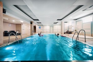 Indoor pool, open 7:00 AM to 10:00 PM, pool loungers, lifeguards on site