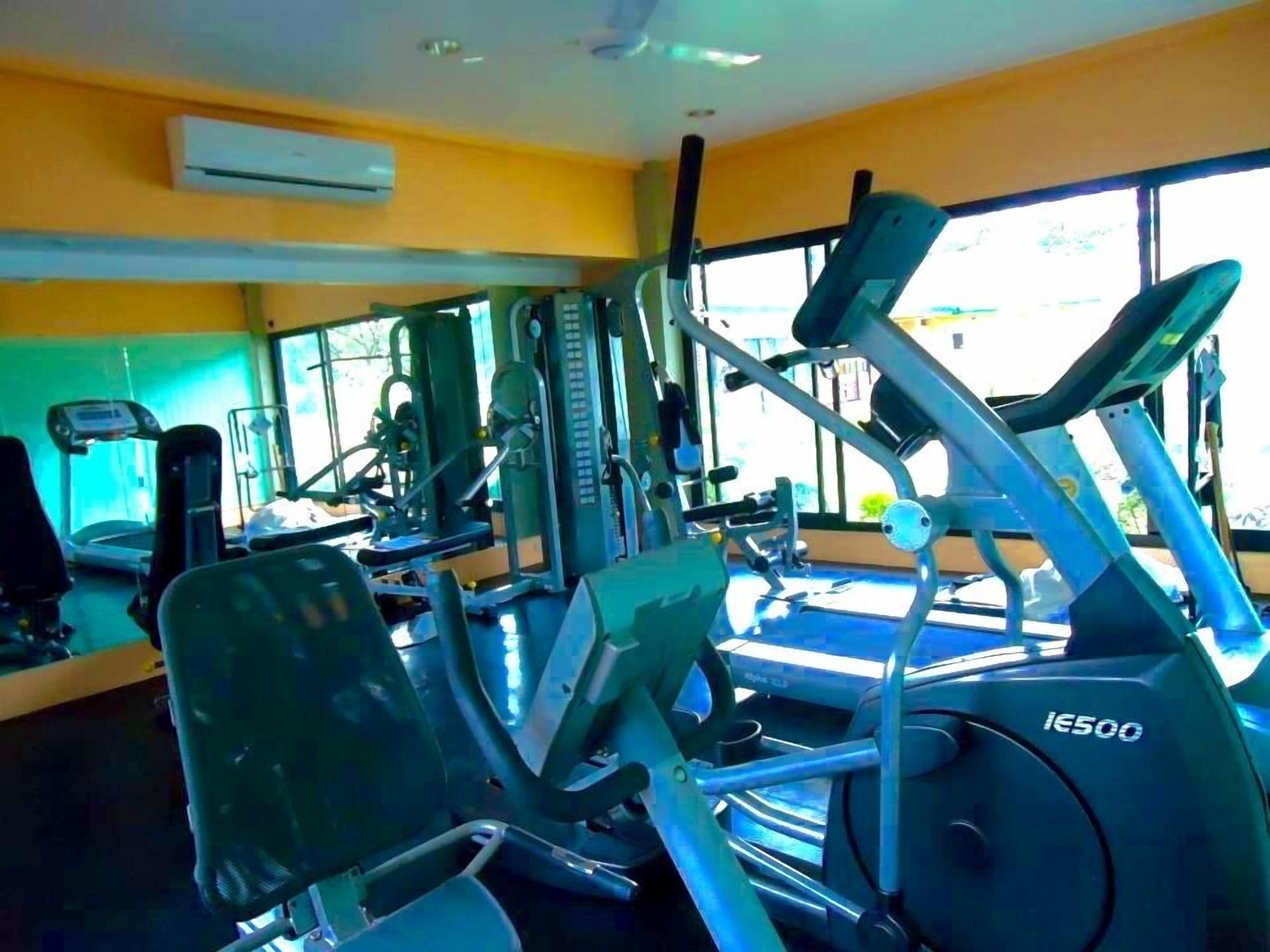 A gym with various exercise equipment, including treadmills and weight machines.