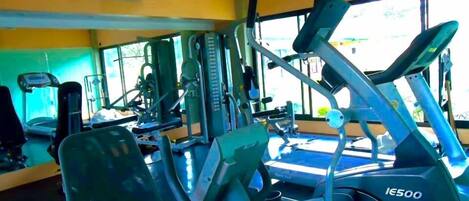 A gym with various exercise equipment, including treadmills and weight machines.