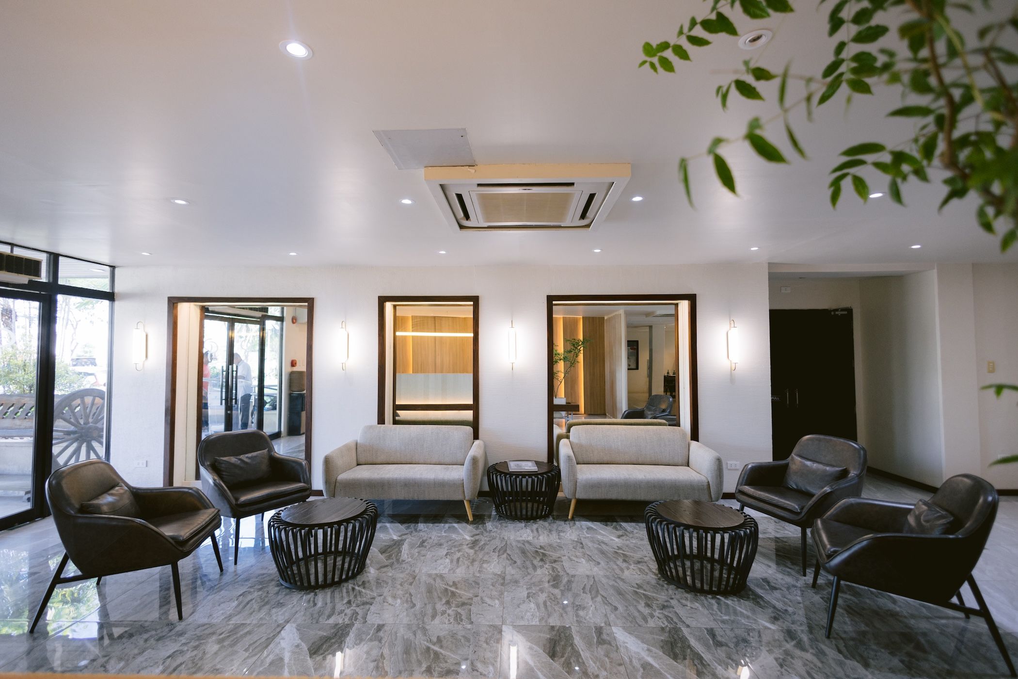 A modern interior with a sofa set, armchairs, and a coffee table.