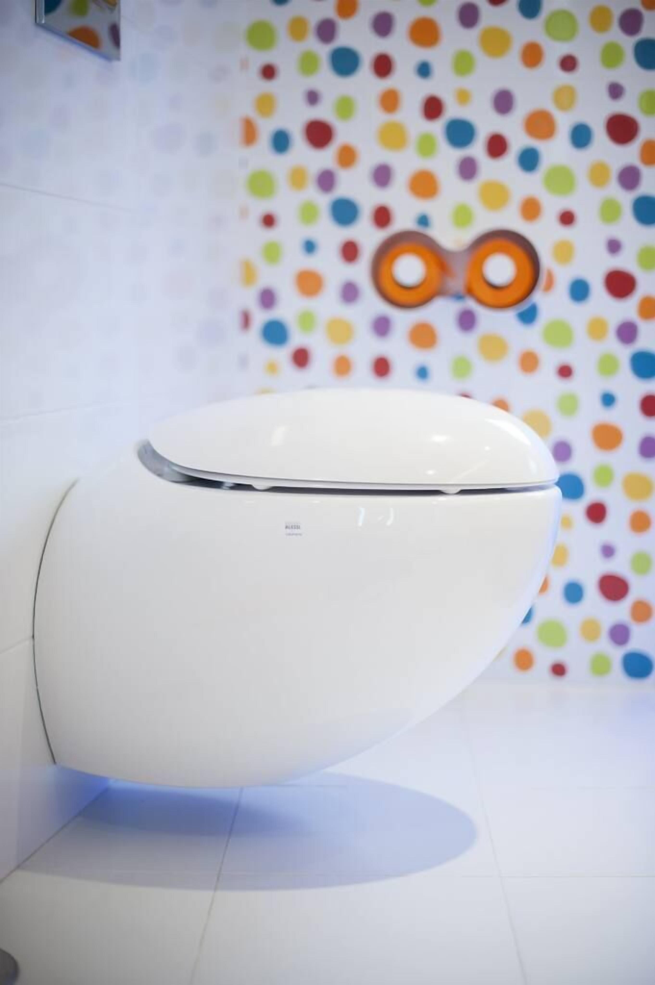 Un inodoro moderno con tapa blanca y nombre de marca visible.