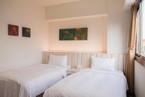 A hotel room with two beds, a nightstand, and a painting on the wall. - CU Hotel Taichung (Taichung)