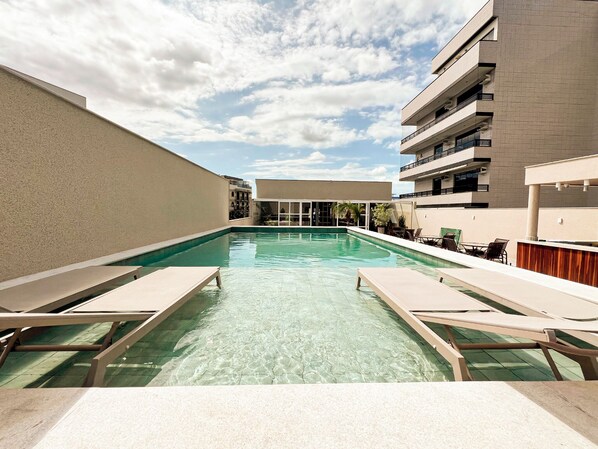 Outdoor pool, a rooftop pool, open 10:30 AM to 9:00 PM, pool umbrellas