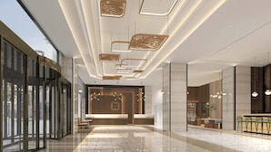 A modern hotel lobby with a marble floor, a reception desk, and contemporary lighting fixtures. - Hilton Garden Inn Wuhan Hankou (Wuhan)