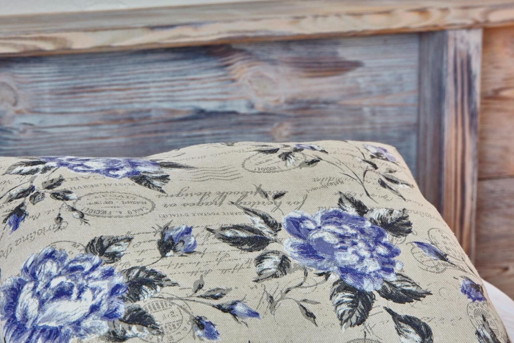 A close-up of a fabric with floral patterns and text, likely part of a piece of furniture.
