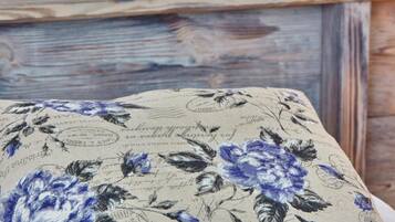 A close-up of a fabric with floral patterns and text, likely part of a piece of furniture.