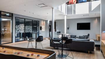 Relax in our spacious lobby, featuring a ping pong table, comfortable seating, and a dining area.