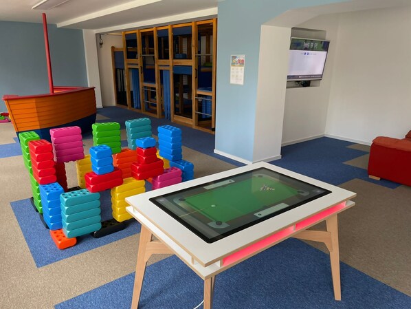A play area with colorful building blocks and a table tennis table.