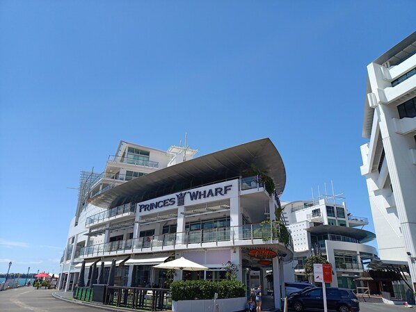 A multi-story building with a prominent sign reading "PRINCES WHARF".