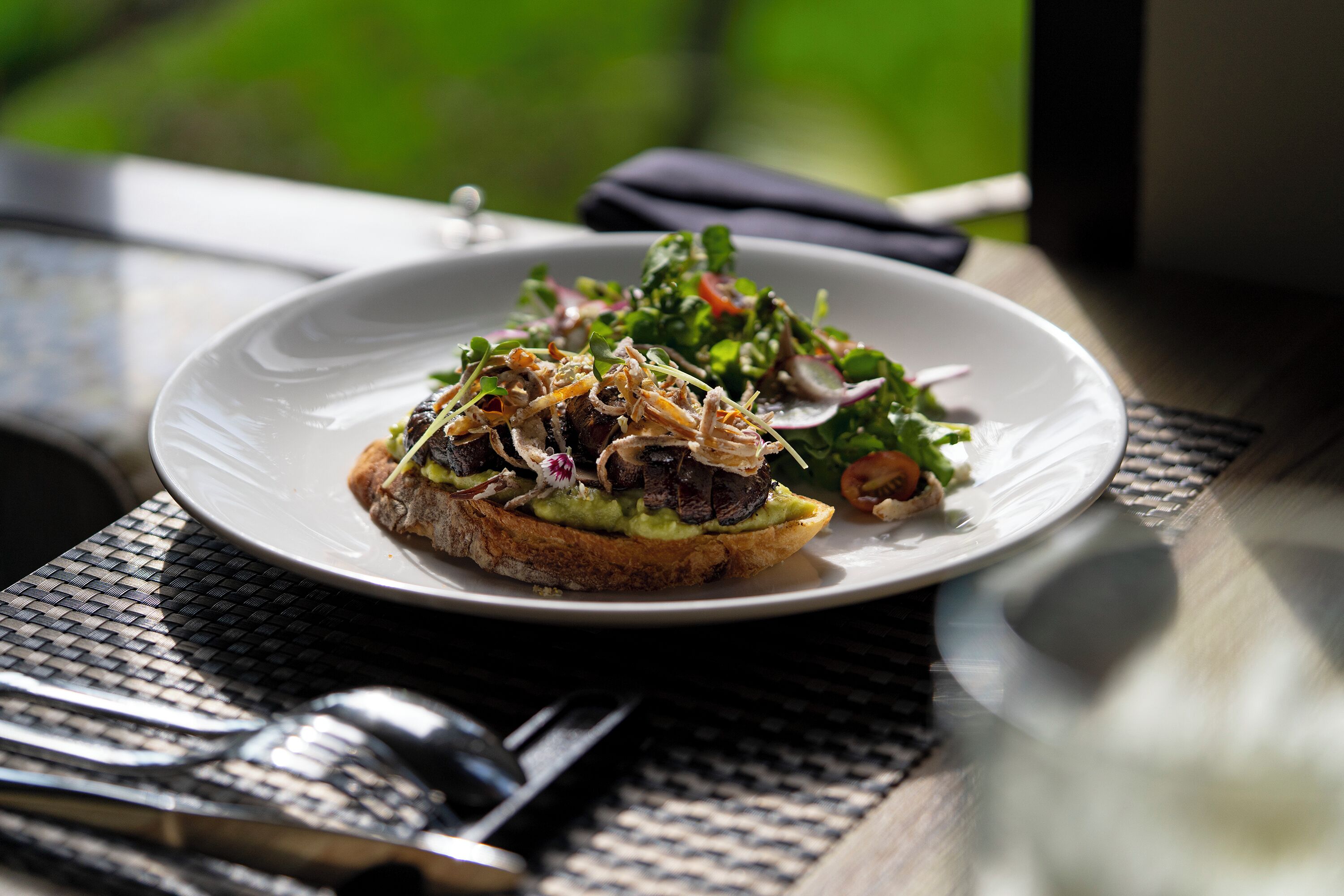 A plate of food on a table with a woven placemat.