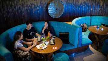 Relax in a cozy lounge area with a curved sofa set and round table, perfect for small groups.
