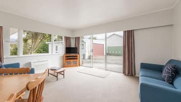 Quadruple Room, 4 Bedrooms | Living area | Flat-screen TV