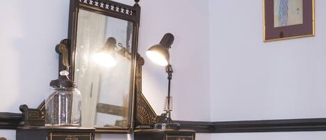 A dark wooden dresser with multiple drawers and a large mirror.